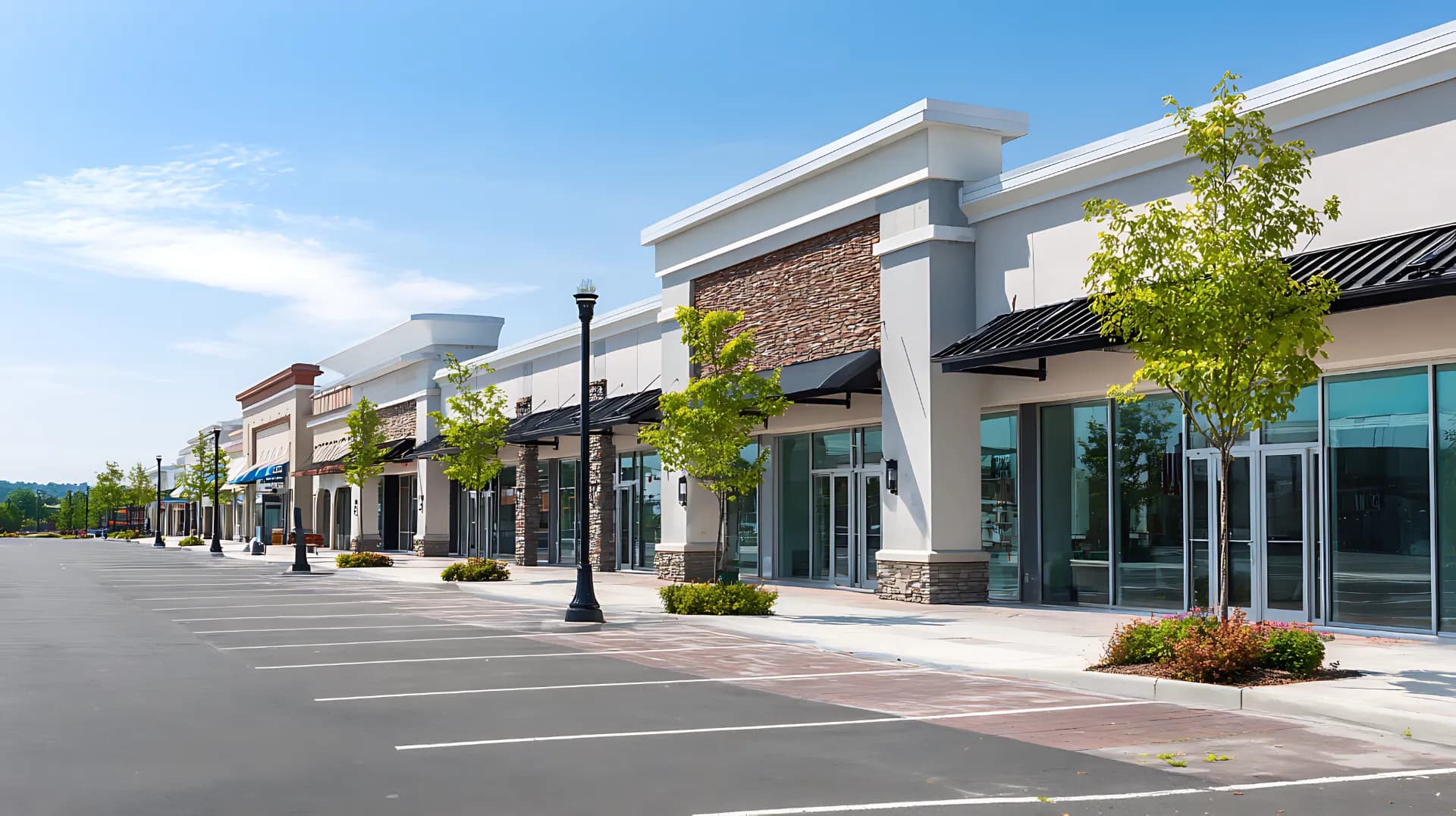Commercial retail plaza with storefronts and parking area