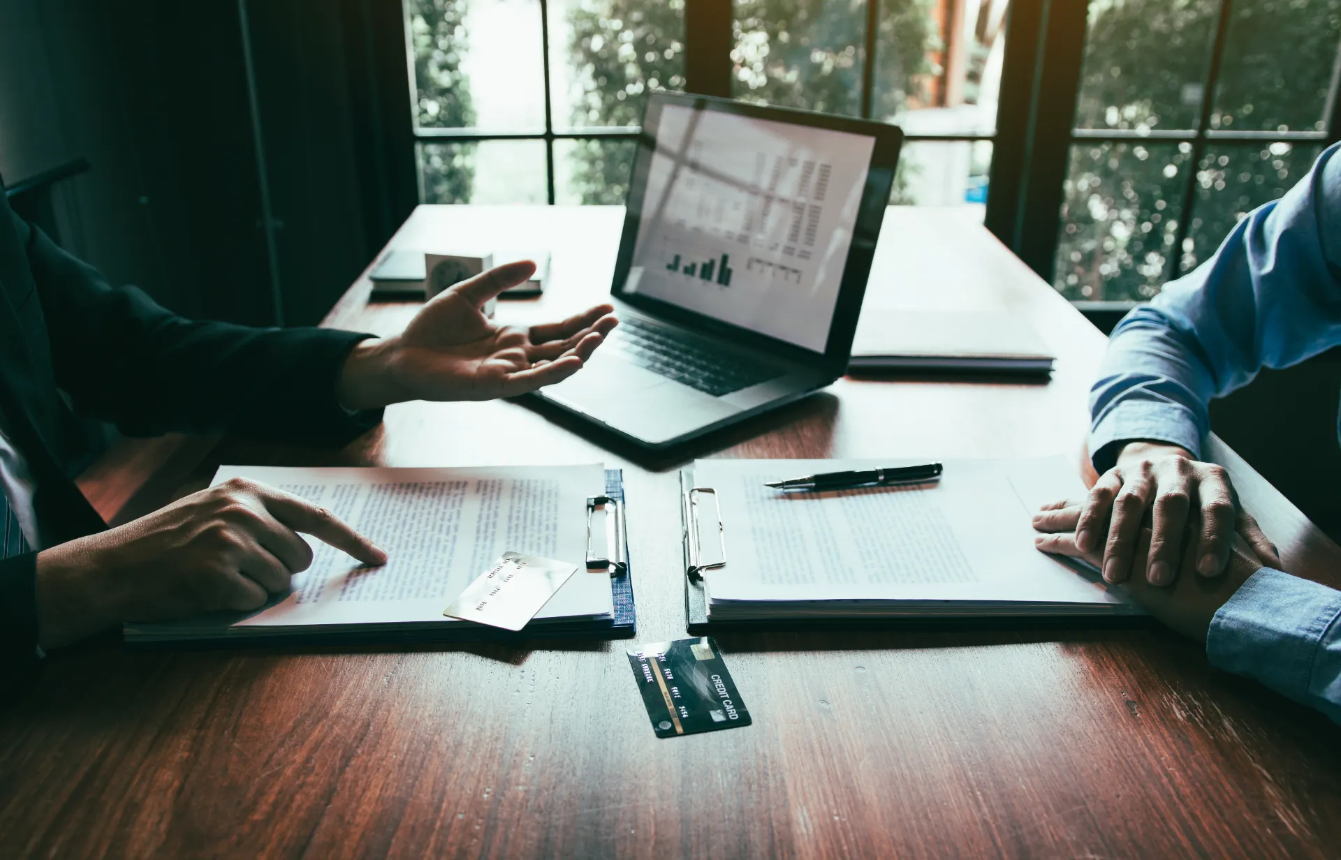 Mortgage broker reviewing financing options and documents with a client.